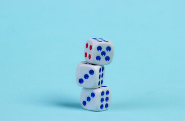Stack of three dice on a blue background