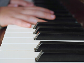 Obraz premium Practicing on piano, Teenager's hand, black and white keys, Concept developing finger's motion skill,