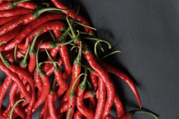 curly chili pepper on black isolated background
