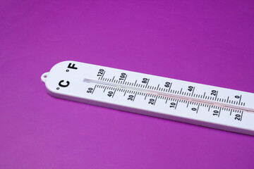 Weather thermometer on purple background. Climate control.
