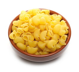 Pasta lumaconi rigati pile in clay bowl isolated on white background