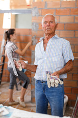 Confident man in building under construction