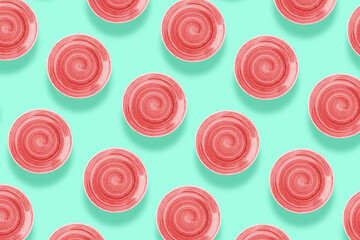  Coral round ceramic plate with spiral pattern, on saturated aquamarine color background