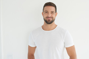Portrait of casual young man standing at isolated white background