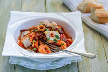 Bouillabaisse (a traditional ProvenÃ§al fish stew) with crispy chorizo and lemon