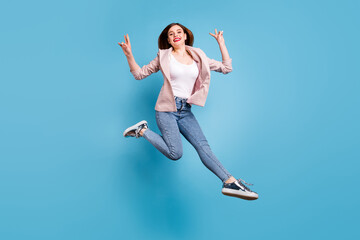 Fototapeta na wymiar Full body photo of cheerful lovely pretty girl jump make v-sign wear plaid blazer sneakers isolated over blue color background