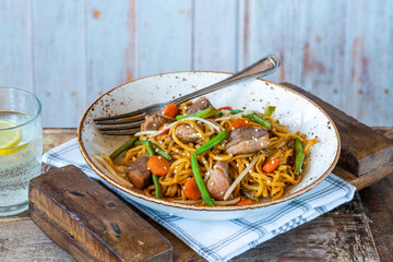 Stir fry duck fillets with noodles, vegetables and hoisin sauce