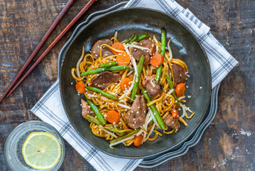 Stir fry duck fillets with noodles, vegetables and hoisin sauce