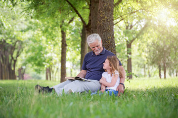 Naklejka na ściany i meble Grandfather with Granddaughter at park