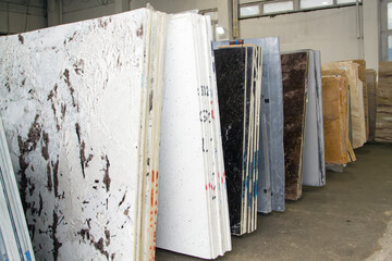 Colorful marble slabs in store show room. Granite slabs are prepared for sale in store yard