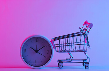Shoping trolley with clock in trendy neon light. Gradient pink-blue glow. Concept art. Minimalism