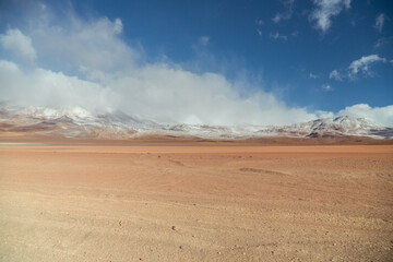 Landscape mountain Water Lake. Dry, Barren desert, snowcapped mountains wilderness. Mountain range view. Salt Flats, Uyuni, Bolivia. Copy space, Rocks, blue sky, nature, hiker, hiking