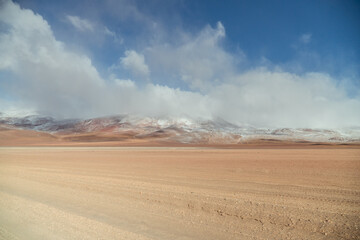 Landscape mountain Water Lake. Dry, Barren desert, snowcapped mountains wilderness. Mountain range view. Salt Flats, Uyuni, Bolivia. Copy space, Rocks, blue sky, nature, hiker, hiking