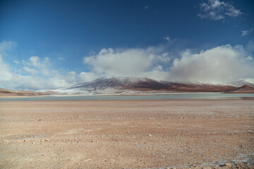Landscape mountain Water Lake. Dry, Barren desert, snowcapped mountains wilderness. Mountain range view. Salt Flats, Uyuni, Bolivia. Copy space, Rocks, blue sky, nature, hiker, hiking