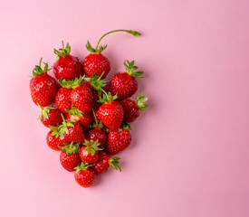 Strawberries on pink background. Top view.