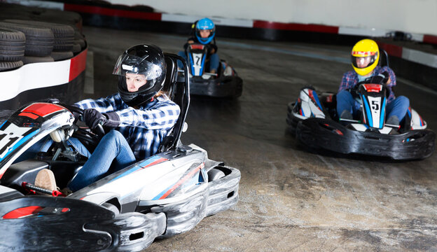 Young people driving sport cars for karting