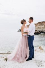 Loving couple on the seashore. Wedding. Newlyweds.