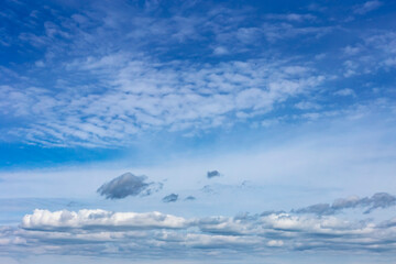 beautiful blue sky with white cumulus and cirrus clouds as a natural background