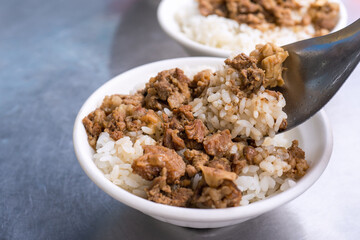 Braised meat rice, stewed beef over cooked rice in Tainan, Taiwan. Taiwanese famous traditional street food delicacy. Travel design concept, closeup.