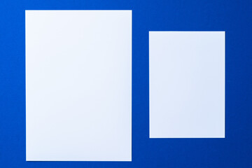 Blank paper business mock up on classic blue background