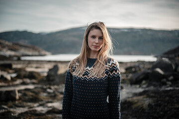 Travel close up portrait of young woman during a time enjoyed next to a fjord