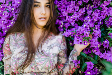 Fototapeta premium young woman between lilac flowers