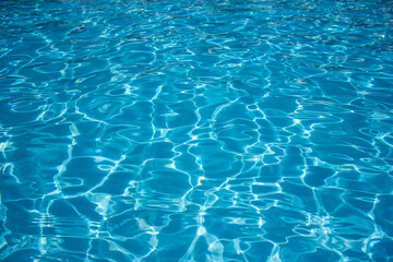 Azure water outdoor swimming pool with reflections of sunlight