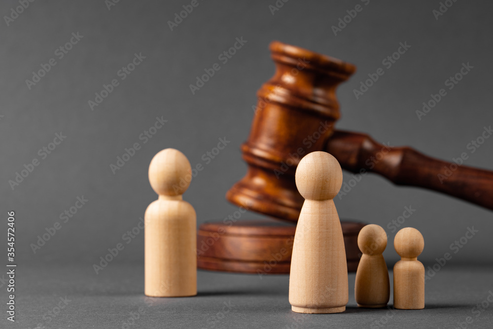 Wall mural wooden toy family and judge mallet. family divorce concept