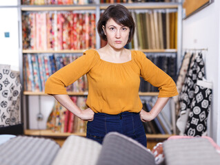 Displeased woman in fabric shop