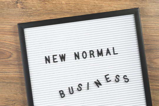 NEW NORMAL Business text on white letter board background. Adapting to new life post-lockdown change after COVID pandemic. Business with social distancing personal hygiene, travel and study poster