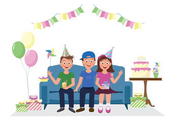 Joyful kids at the birthday party are sitting on the couch. Children in caps. Candles are burning on the cake.