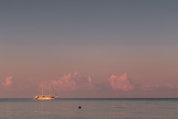 Sailboats on ackground of sunset over sea