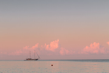 Sailboats on ackground of sunset over sea