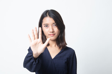 Portrait of an asian woman showing stop gesture.