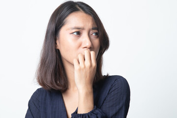 Unsure hesitant nervous young asian  woman biting her fingernails.