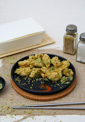 Delicious chiken chop with seaweed seasoning. Chicken chop on black plate.