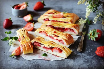 Homemade strawberry yeast pie on a gray background
