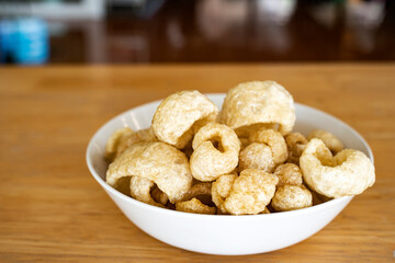 Pork rind, pork crackling on a wooden table