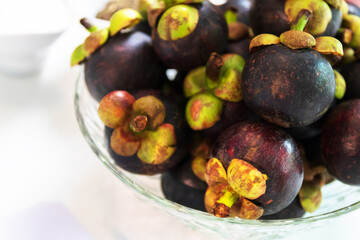 Fototapeta na wymiar The purple mangosteen (Garcinia mangostana), known as the queen of fruits. Health benefits of mangosteen include a reduced risk of cancer, inflammation, allergies and diabetes.