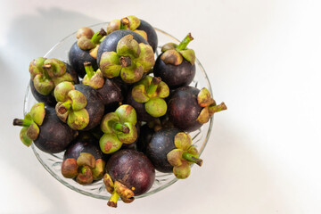 The purple mangosteen (Garcinia mangostana), known as the queen of fruits. Health benefits of mangosteen include a reduced risk of cancer, inflammation, allergies and diabetes.