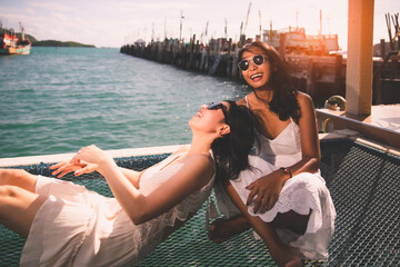 Attractive girls friend happy laughing and smiling together at seaside