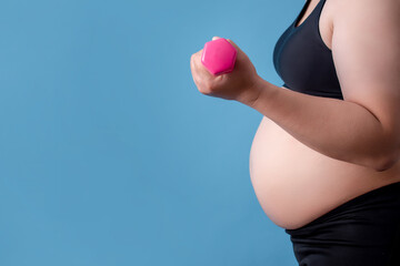 Overweight women are holding dumbbells on the blue background and isolated background.