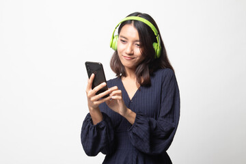 Pretty asian girl listening music with her headphones.