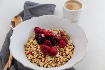 Healthy breakfast concept. Granola with coffee and berries.