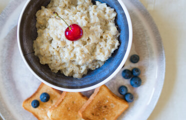 Healthy breakfast. Oat Flakes Porridge with toasts.