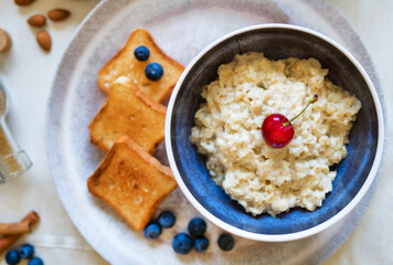 Healthy breakfast. Oat Flakes Porridge with toasts.