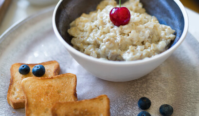 Healthy breakfast. Oat Flakes Porridge with toasts.