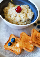 Healthy breakfast. Oat Flakes Porridge with toasts.