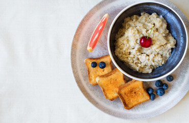 Healthy breakfast. Oat Flakes Porridge with toasts.