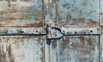 hinge on a rusty metal door. vintage iron background